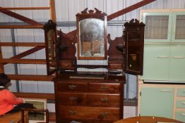 An Edwardian walnut dressing chest with mirrored b