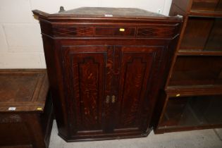 A Georgian oak and inlaid double corner cupboard