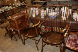 A pair of elm seated stick back elbow chairs