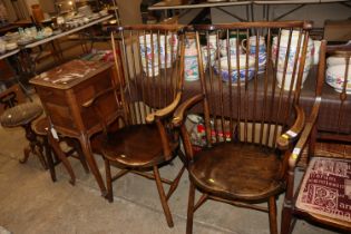 A pair of elm seated stick back elbow chairs