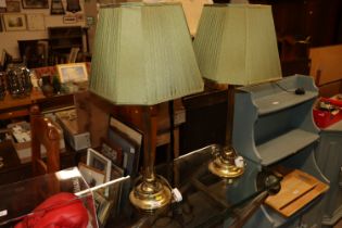 A pair of brass table lamps and shades