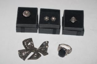 Two silver and marcasite rings; another silver rin