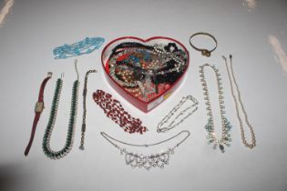 A heart shaped box with contents of crystal neckla