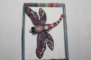 A large decorative dragonfly brooch