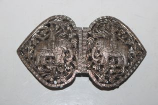 A white metal nurses buckle with pierced decoratio