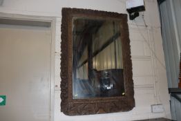 A carved oak wall mirror