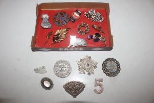 A box of assorted brooches