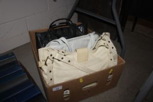 A box containing four vintage leather handbags