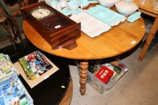 A cherry wood drop leaf dining table