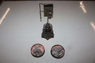 A scrap metal model and two tins containing unpain