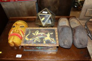 A pair of wooden clogs; a painted face mask; a gil