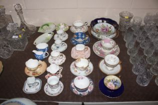 A collection of various tea cups and saucers inclu