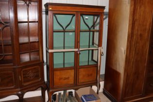 An Edwardian inlaid mahogany china display cabinet