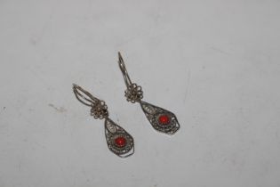 A pair of white metal filigree work coral set ear-