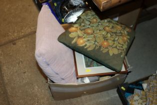 A box containing various pictures and cushions