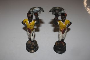 A pair of cold painted Blackamoor figural candlest