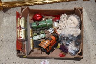 A box containing tin plate clockwork trains; Chris