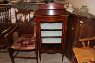 An Edwardian mahogany and cross banded china display cabinet with bow front door