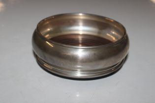 A silver bottle coaster with turned wooden base, H
