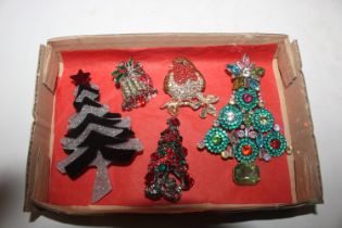 A box containing Christmas brooches