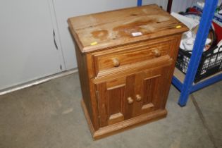 A stripped pine side cupboard fitted single drawer