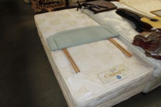 A Rest Assured single bed with mattress and headbo