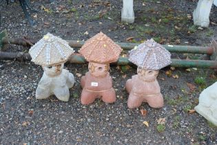 Three concrete garden lanterns