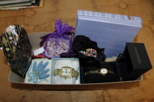 A box containing bead and shell decorated necklace