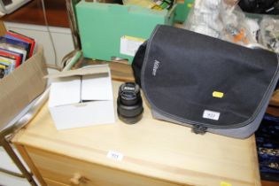 A Nikon camera lens and a Nikon camera carrying ca