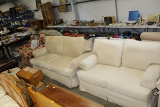 An upholstered three seater settee and matching tw