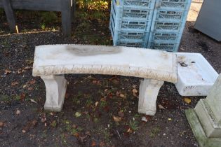 A concrete garden bench