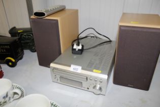 A Denon CD receiver with remote control and pair o