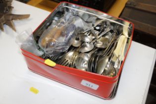 A tin of miscellaneous cutlery etc.