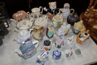 A collection of novelty teapots etc.