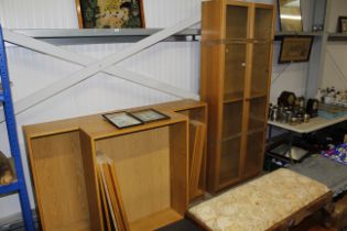 A light oak effect glazed cabinet and three shelve