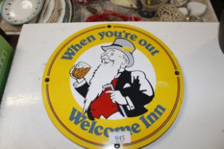 A circular pub type sign 'Welcome Inn'