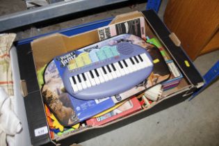 A box of children's toys, Yamaha keyboard, a table cover etc.