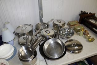 A collection of stainless steel saucepans, frying