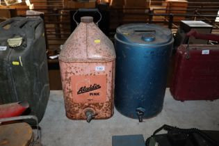 An Aladdin Pink Paraffin can and a blue paraffin can