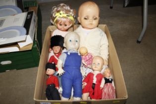 A box of various dressed dolls