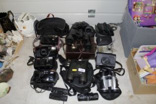 A collection of various cameras and binoculars