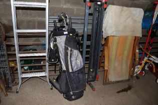 A golf trolley bag and clubs