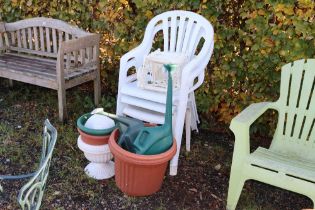 Three plastic garden chairs; two watering cans; ga