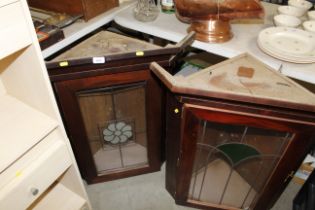 Two hanging corner cupboards with coloured glass d