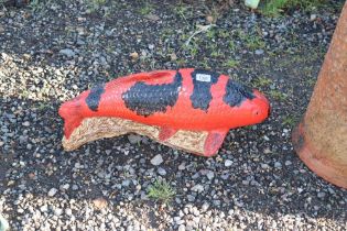 A concrete garden ornament in the form of painted Koi carp