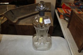 An hour glass shaped decanter with silver collar