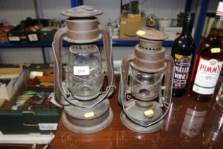 Two hurricane lamps