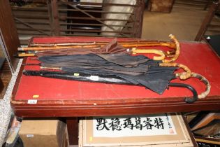 A collection of walking sticks and umbrellas