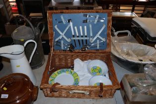 A wicker picnic basket and contents