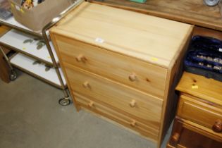 A pine effect three drawer chest